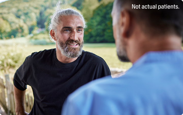 A man speaking with a friend