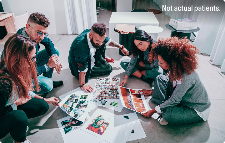 A group of people looking at photos