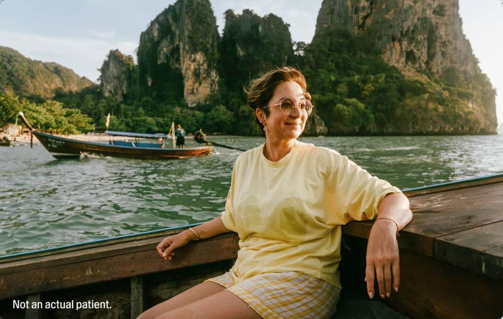 Woman sitting by the water.